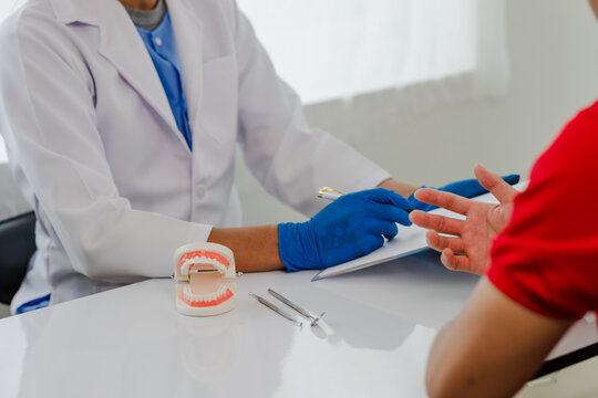The doctor talks to the patient about oral care. dental care