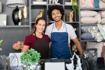 Brazilian couple smiles for portrait in a neighborhood shop.