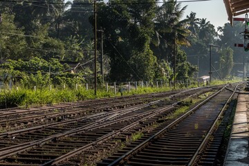 Naklejka premium view down the track to the train station at sunset time