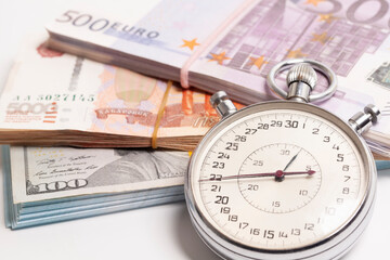 Time is money concept, stopwatch on euro ,dollars, Russian rubles banknotes