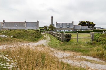 Fototapeta na wymiar Lighthouse surrounded by greenery in Bretagne, France
