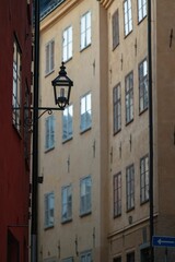Fototapeta na wymiar Vintage street lamp with old town buildings in the background.