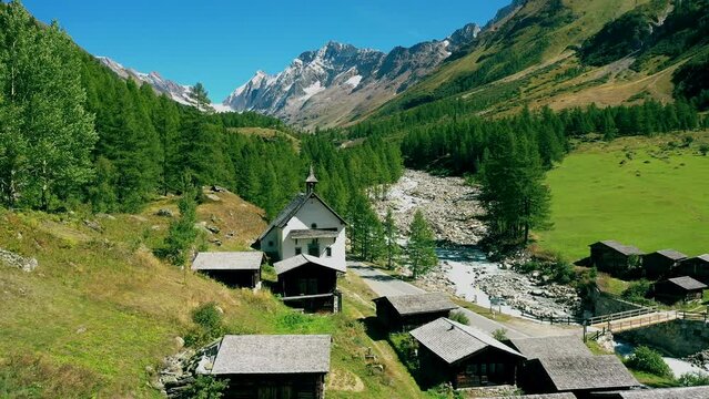 Kuehmad stable village with pilgrimage chapel with view of the Loetschenluecke, Blatten Loetschental Valais Switzerland