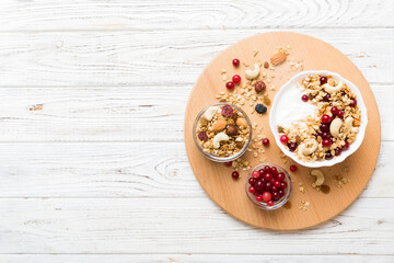 Healthy breakfast food with granola, yogurt, fruits and nuts. Dessert parfait with dried fruits for breakfast