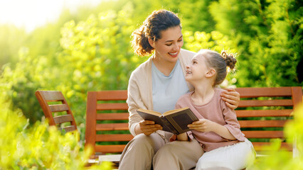 girl and her mother reading a book
