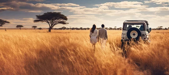  Young couple on African safari, walking back to their 4wd car over savanna with tall brown grass. View from behind. Generative AI © Lubo Ivanko