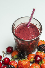 A beautiful clear glass tumbler with a purple and white straw filled