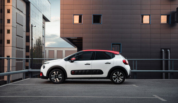 White n red Citroen C3 hatchback in front of the anthracite modern building. side profile view of compact car. Kyiv, Ukraine - April 28 2017.