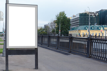 Naklejka premium Vertical billboard for advertising and text in the city. Black steel railing. Mock-up.