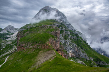 Julian Alps mountain Mangart from Mangrt saddle, Slovenia's Highest Panoramic Road, foggy weather