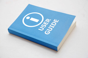 User guide book, Blue cover book on white background, instruction manual for user training  - Powered by Adobe