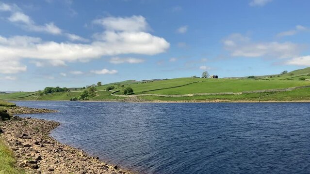 The beautiful water of Grassholme Reservoir and surrounding rolling green hills of Upper Teesdale. Taken in summer on a sunny day - Nr Barnard Castle, County Durham, UK