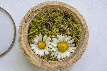 wedding ring pillow burlap in wooden box in front of flower bouquet rings of love