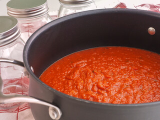Marinara Sauce in Kettle with empty Canning Jars 
