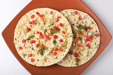 Masala papad is roasted urad dal papad with salad toppings