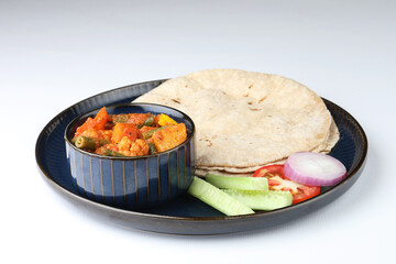 mix veg sabji, chopped cucumber, onion, tomato with roti is a complete Indian meal