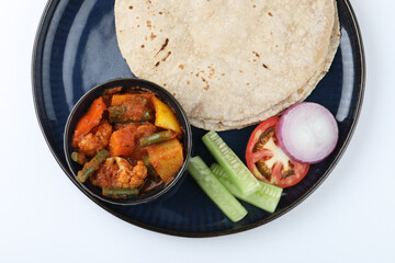 mix veg sabji, chopped cucumber, onion, tomato with roti is a complete Indian meal