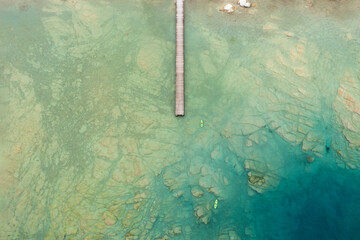 aerial view of a jetty and two canoes on lake garda near sirmione