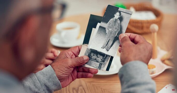 Hands, picture and memory with senior friends thinking about the past while in a nursing home. History, vintage and retirement with an elderly group holding a photograph closeup to remember life