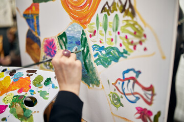 child painting eggs in the garden