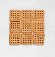 Sweet square shaped biscuits on a white background. Top view.