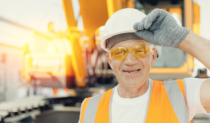 Portrait happy Engineer Man professional background yellow big truck excavator on building...