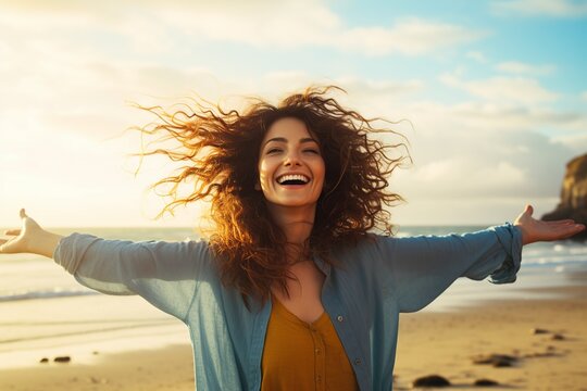woman with arms outstretched enjoying freedom on the beach