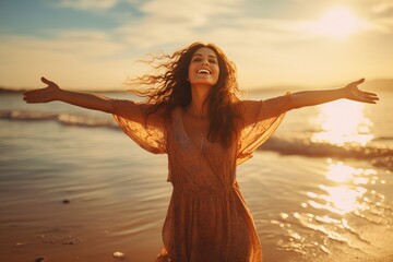 Fototapeta na wymiar woman with arms outstretched enjoying freedom on the beach