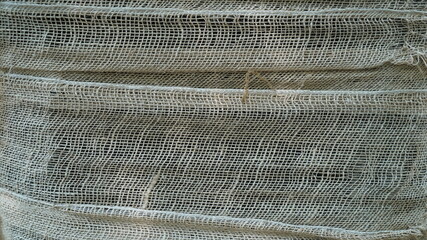 A white cloth net wrapped around a tree