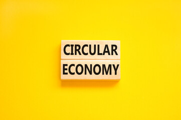 Circular economy symbol. Concept words Circular economy on beautiful wooden block. Beautiful yellow table yellow background. Business circular economy concept. Copy space.
