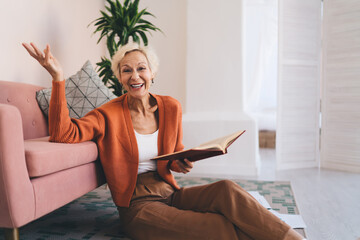 Joyful elderly woman showing excitement while reading book