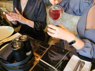 Woman pouring healthy cranberry juice into a glass
