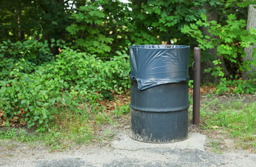 urban debris, a solitary trashcan stands as a symbol of waste, neglect, and our responsibility to preserve the environment