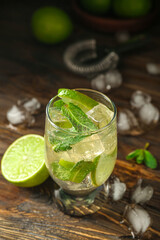 Glass of tasty mojito on wooden background