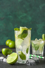 Glass of tasty mojito on table