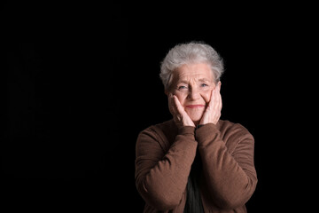 Obraz premium Senior woman on black background