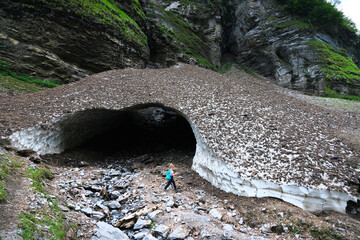 Cirque du Fer-a-Cheval with Bout du Monde, the most grand alpine mountain cirque, limestone of 4 to 5 kilometers of development, walls of 500-700m high, Haute- Savoie, France.  Ice Cave on the trail.