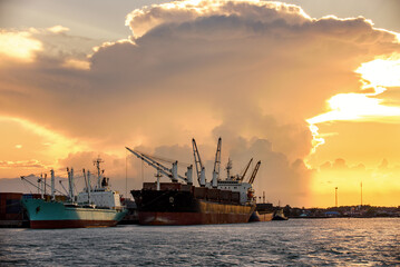 Cargo ship loading containers at sunshine