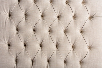 upholstered headboard with textile upholstery and studded buttons