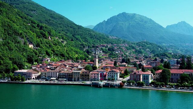 Aerial 4K footage of a flight over Porlezza town, Lugano Lake. Panoramic drone video of town in Lugano Lake between Switzerland and Lombardy, Italy