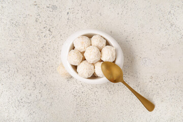 Delicious white chocolate candies with coconut topping on light table