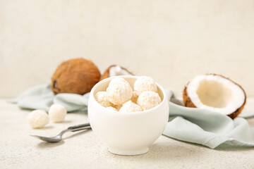 Delicious white chocolate candies with coconut topping on light table