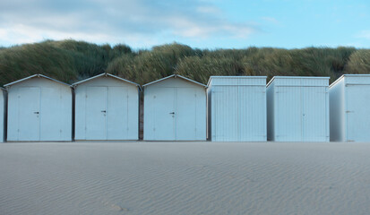 white beach huts at the beach