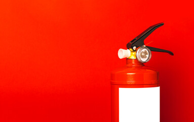 Fire extinguisher on red texture background. Fire protection, home fire extinguisher. home security...