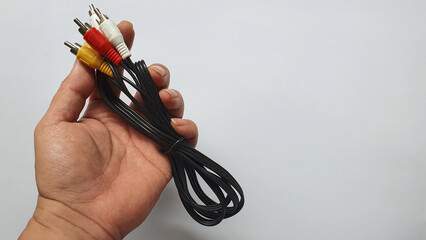 Hand holding a RCA cable