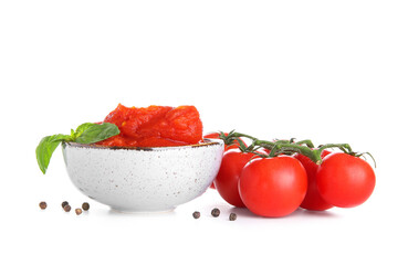 Bowl of canned tomatoes and spices on white background
