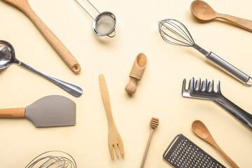 Composition with different kitchen utensils on color background