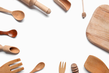 Frame of wooden kitchen utensils on white background