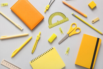 Different school stationery and notebooks on grey background - obrazy, fototapety, plakaty