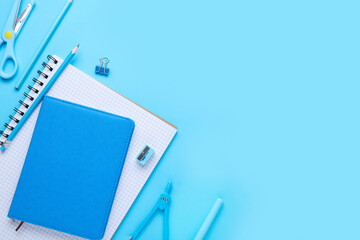 Set of stationery with notebooks on blue background